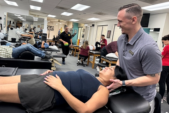 Chiropractor Thousand Oaks CA Zack Fulks Adjusting Patient HP Chiropractor Zack Fulks Adjusting Patient Lying On Their Back