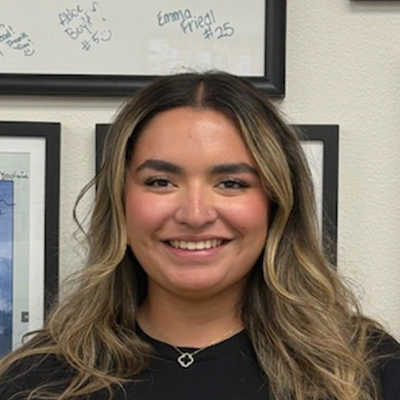 Rehabilitation Aide Grace Herrera Smiling In Black T-Shirt