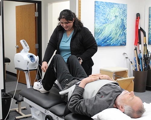 Patient Receiving Spinal Decompression Therapy On Mechanical Table