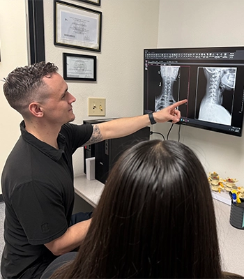 Chiropractor Zack Fulks Pointing To Patients XRays